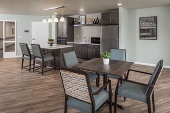 A dining room with a table and chairs.